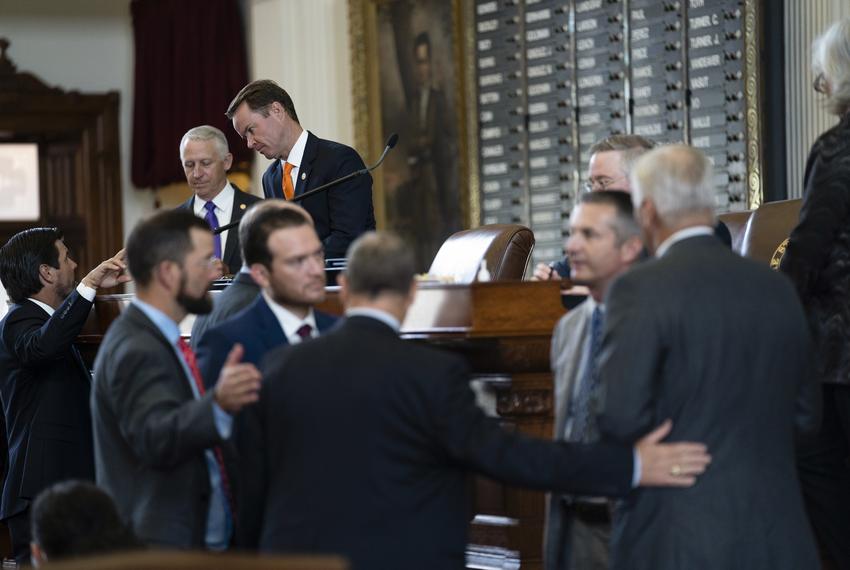 House Speaker Dade Phelan talks with other legislators on the House floor on July 20, 2021.