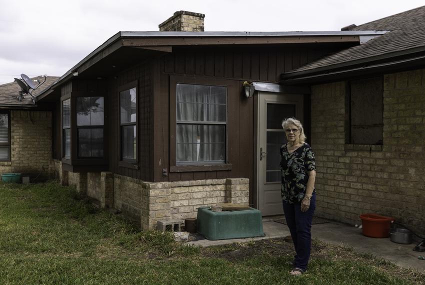 Peggy Bell stands outside her home in Robstown on May 3, 2022. Bell has lived in her home since building it in 1981. Her home flooded twice last year and she says trash and the overgrowth of brush downstream is to blame.