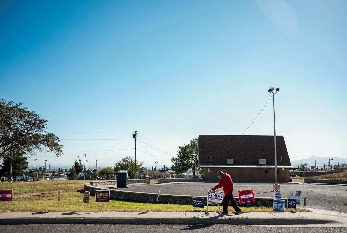 Francisco A. Morua, 95, walks home past campaign signs after casting his vote at the Grandview Senior Center on election day in El Paso on Nov. 3, 2020.