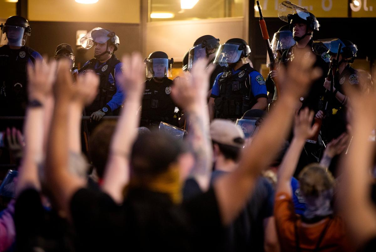 Protesters raise their arms and chant, “Don’t shoot!” after Austin police officers fired tear gas and rubber bullets at the crowd. May 30, 2020. 