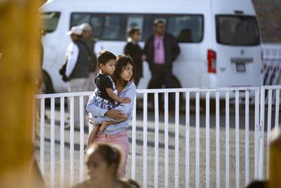 A young woman holds a child inside the migrant shelter in Piedras Negras, Coahuila on Feb. 18, 2019.