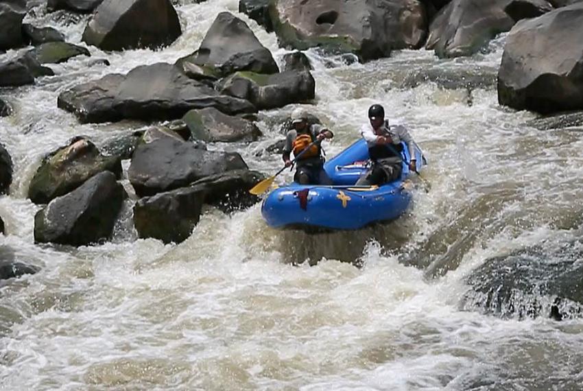 Garret Schooley, left, and Neil Cheesewright take a two man raft down the Upper Box of the Rio Grande Gorge.