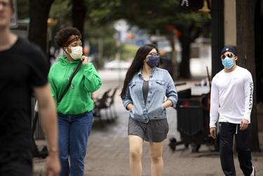 Pedestrians wearing masks to protect against COVOD-19 in downtown Austin on June 24, 2020.