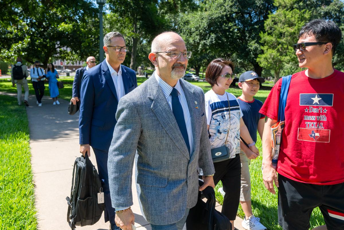 Texas Democrats Jon Rosenthal, D-Houston and Rafael Anchia, D-Dallas, l,  get off a charter bus from the Austin airport outside the State Archives building on the east side of the Texas Capitol upon their return to Austin following a two-week quorum break.  Man at right is unidentified.
