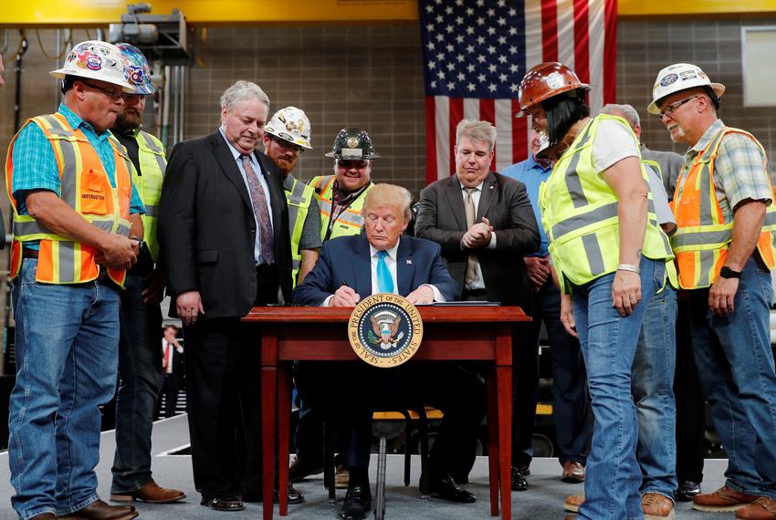 President Donald Trump signs an executive order on energy and infrastructure during a campaign event at the International Union of Operating Engineers International Training and Education Center in Crosby on April 10, 2019.