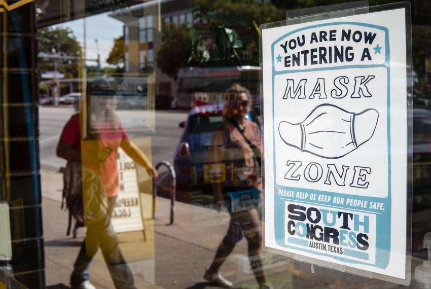 A sign at Big Top, a candy store in Austin, tells patrons that masks are required for entry on July 19, 2021.