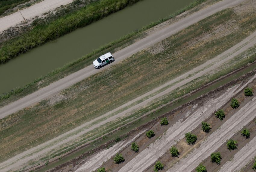 A Customs and Border Protection vehicle patrols on the Texas border near the Rio Grande, Thursday, July 24, 2014, in Mission, Texas. Texas is spending $1.3 million a week for a bigger DPS presence along the border.