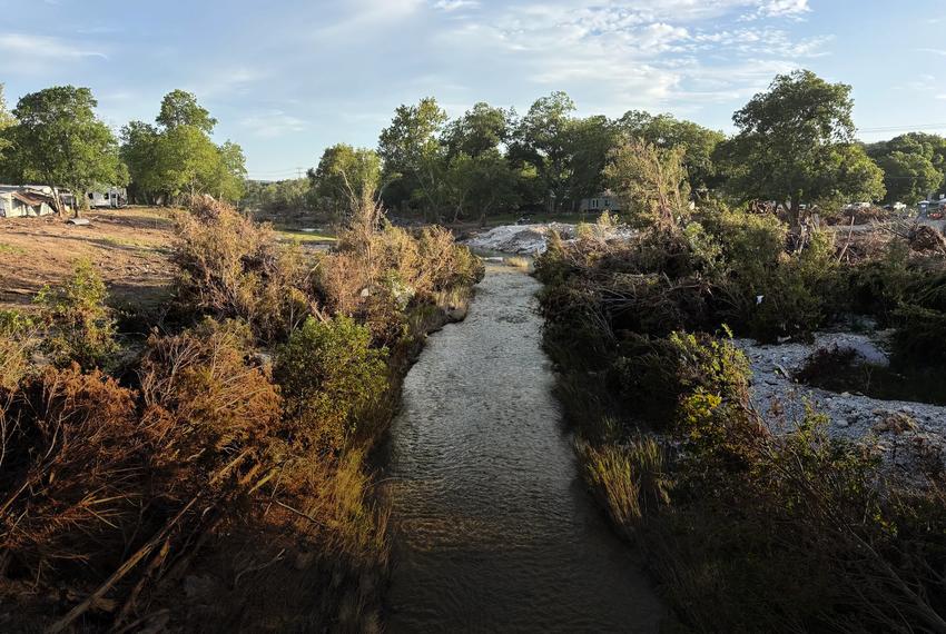Big Sandy Creek, usually dry, flows nearly two weeks after the July 5 flood.