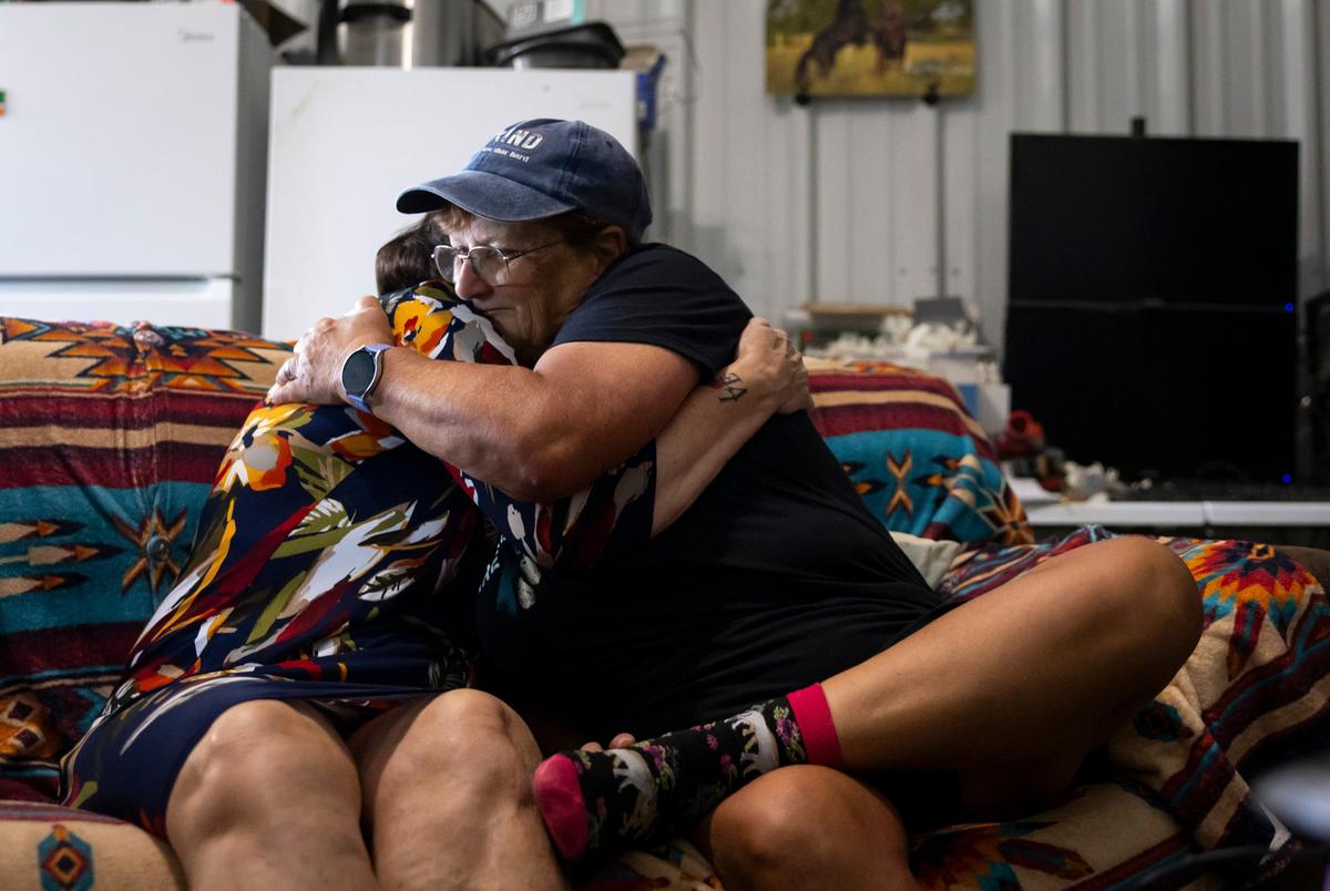 Amy Harper and Romana Harding embrace during an interview on Tuesday, July 29, 2025, outside of Midway, TX.