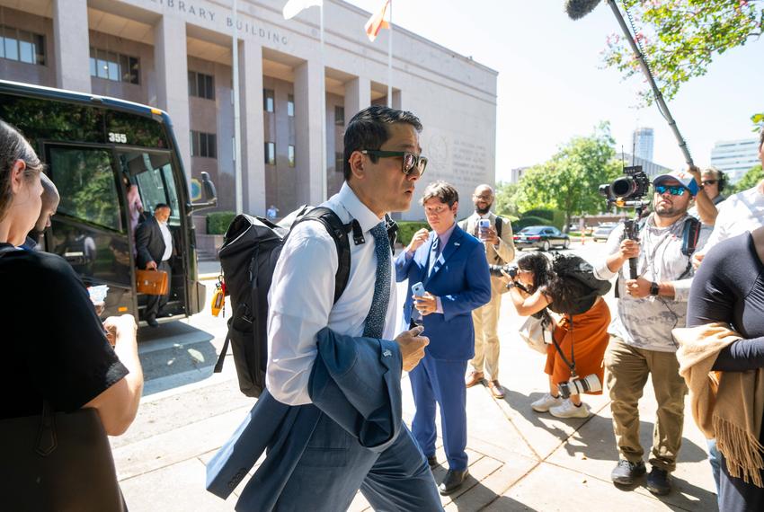 Texas Democratic Caucus chair Gene Wu, D-Houston, gets off a charter bus from the Austin airport outside the State Archives building on the east side of the Texas Capitol upon their return to Austin following a two-week quorum break.