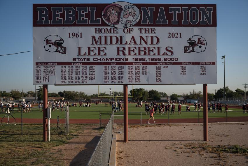 A sign commemorating the Lee High School football team’s championship wins sits outside of their practice field as the current Legacy High School football team meets for a two-a-day practice before the start of the upcoming school year on Thursday, Aug. 7, 2025, in Midland.