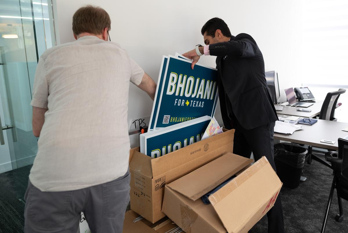 Campaign manger Brain Patrick, left, and Salman Bhojani, a former candidate for Texas Senate District 9, browse through campaign material at Bhojani's offices in Irving, on Oct. 17, 2021. Bhojani suspended his campaign after state legislature adopted new district maps which draw Bhojani's home out of District 9.