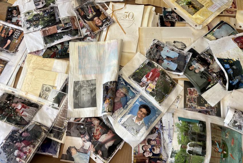 The Hefner family’s water-damaged photographs and mementoes dry out in a shed.
