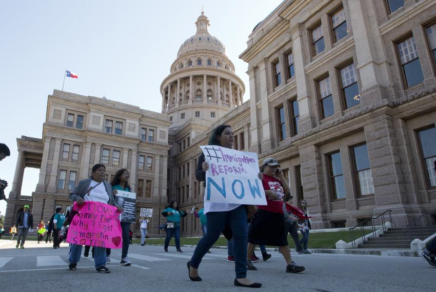 Several pro-immigrant groups march through the Texas Capitol grounds on November 21, 2015