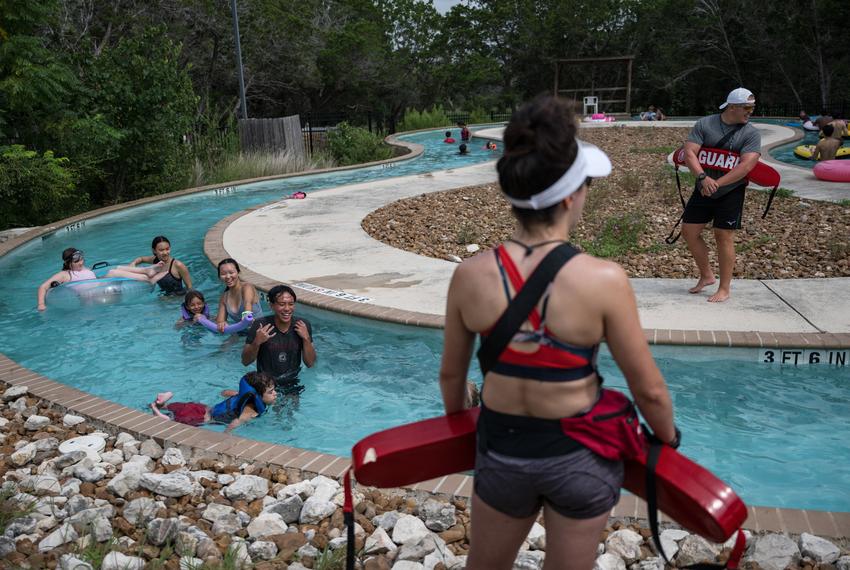 Lifeguards watch over campers and counselors as they float along the lazy river at Camp CAMP, a summer camp hosted by Children’s Association for Maximum Potential for people with disabilities, on Tuesday, July 22, 2025, in Center Point.