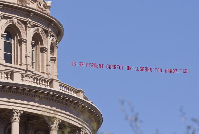 Airplane buzzed over the Capitol during the lunch hour with banner from the Texas Association of Business asking "Is 37 % correct on algebra too hard?"