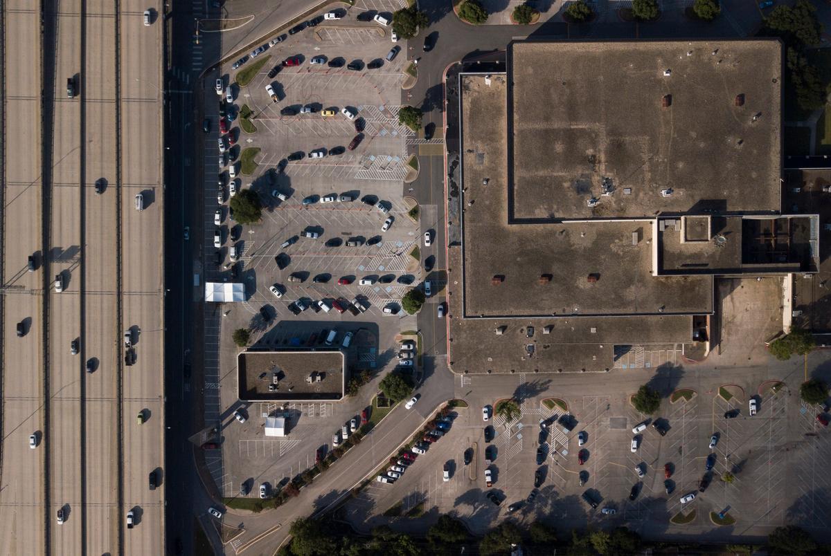 Starting from the bottom right corner, a line of cars snakes through the parking lot at Hancock Center in Austin while waiting for COVID-19 tests at the Community Care clinic. Some patients reported four hour wait times. June 25, 2020.