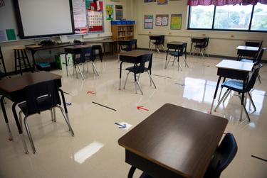 Desks are spaced out in a classroom at Ott Elementary School on Tuesday, Aug. 11, 2020 in San Antonio. The arrows on the floor indicate the direction for students to walk to control the flow of traffic through the classroom.