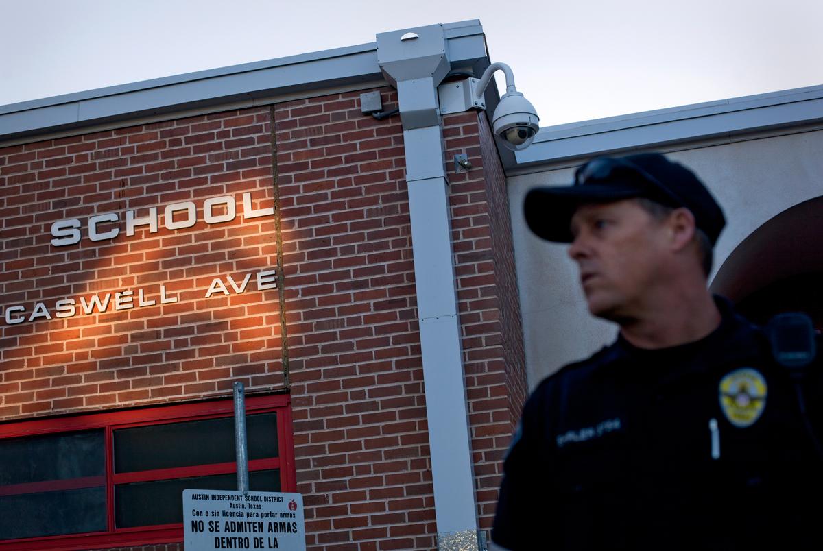 Austin Police Department officer Cory Ehrler monitors the entrance to Ridgetop Elementary School in Austin, Texas shortly after classes start on the Monday following the Sandy Hook Elementary School shooting. As the 83rd Legislature approaches, Texas lawmakers are considering making firearms more available to teachers and other school personnel. The Texas Tribune (Smith: School Security). Credit: Tamir Kalifa for The Texas Tribune.