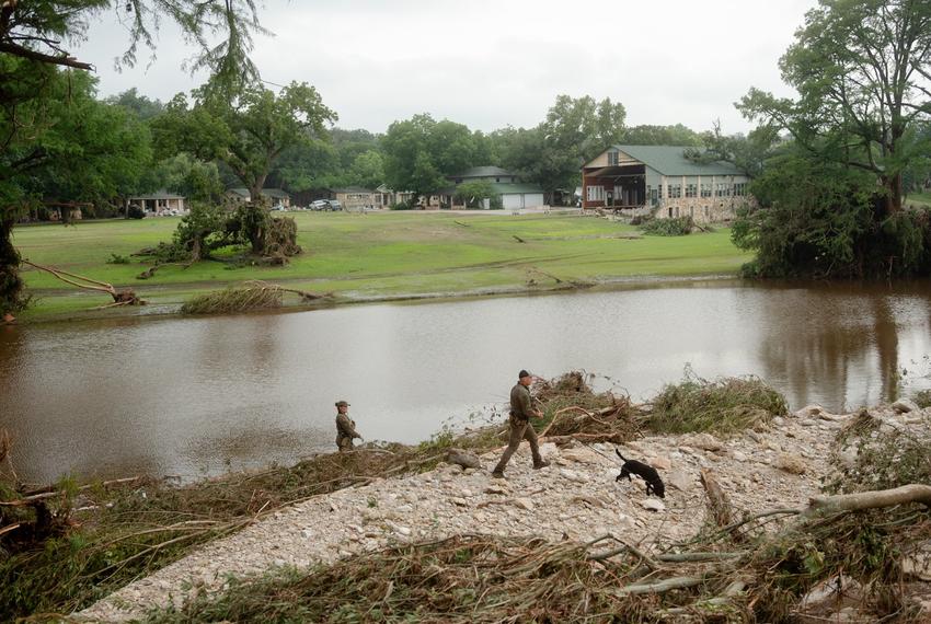 Texas game wardens search the area across the river from Camp Mystic on July 5, 2025.