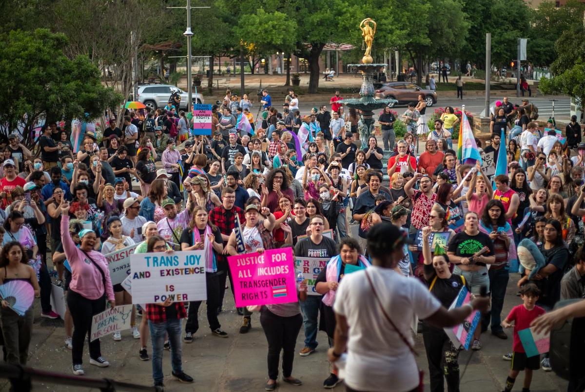 The crowd gathered at a rally for Trans Day of Visibility at the Bexar County Courthouse listens to pediatrician Dr. Lulu in San Antonio on March 31, 2023.