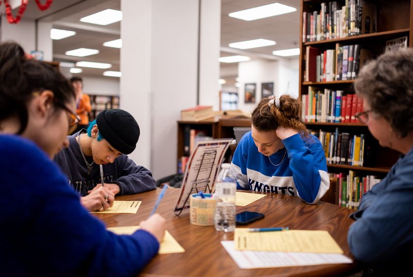 From left: Students Jasmine Barrera, Louis Lor and Liana Smoot register to vote with Pamela Orr at McCallum High School in Austin.