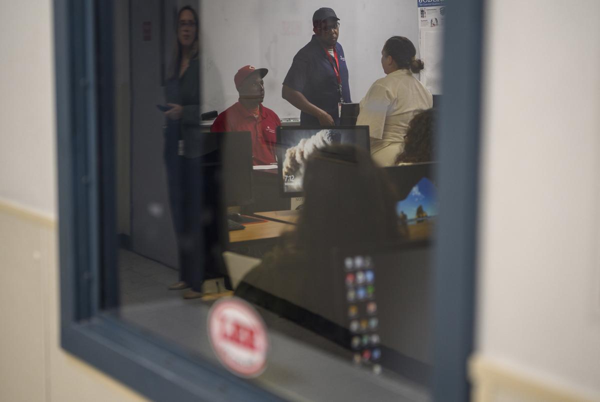 Calvin Green and Tracy Williams speak to a student who is incarcerated as they lead a Lee College course that focuses on reentry for women who are incarcerated at Lucile Plane State Jail in Dayton, Texas, US, on Monday October 28, 2024.