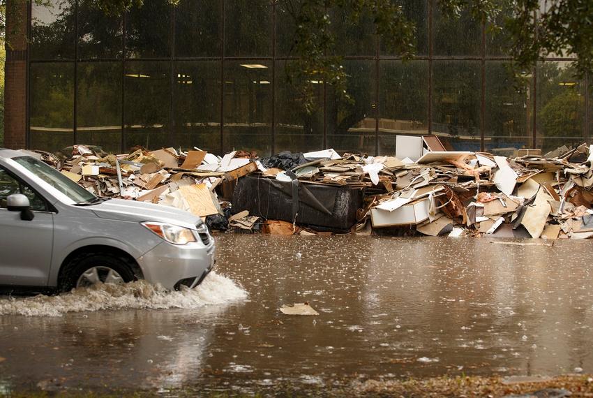 Water remains on a street below the Barker Reservoir dam in Houston on Monday, Sept. 18, 2017.