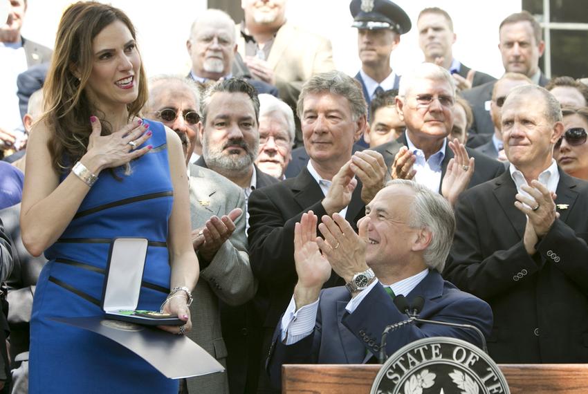 Taya Kyle receives the Texas Legislative Medal of Honor that Gov. Greg Abbott awarded to her late husband, Chris Kyle, on Aug. 26, 2015.