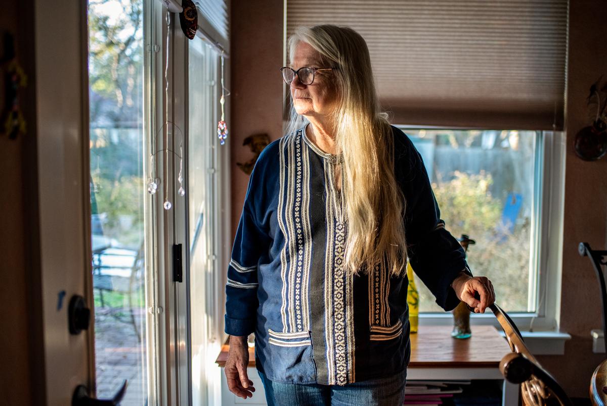 Beth Pierce looks out the window of her home in Austin.