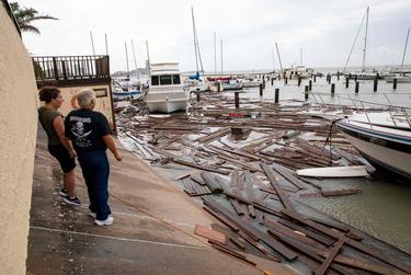 Boat owners survey the damage at Harbor Del Sol Marina the morning after Hurricane Hanna in Corpus Christi.