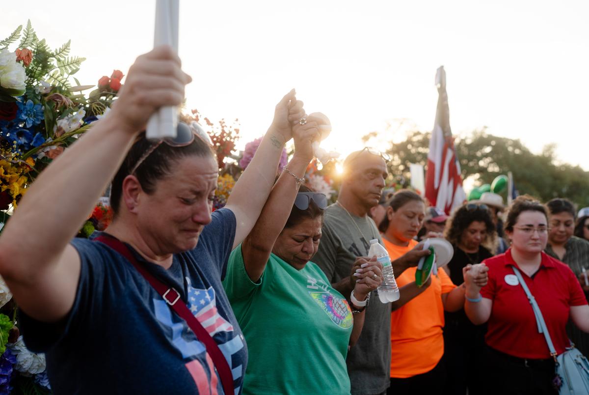Members of the community honor the victims of the flood with a vigil and a memorial on Water St. in Kerrville on Friday July 11, 2025.