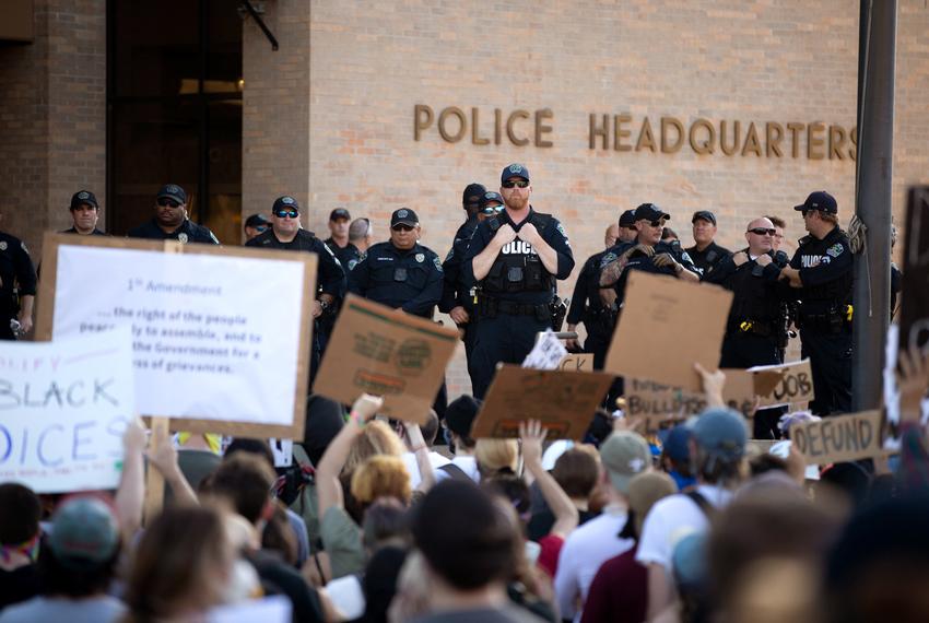 Police look on as demonstrators gathered outside Austin Police headquarters for another night of protest against police violence on June 4, 2020.