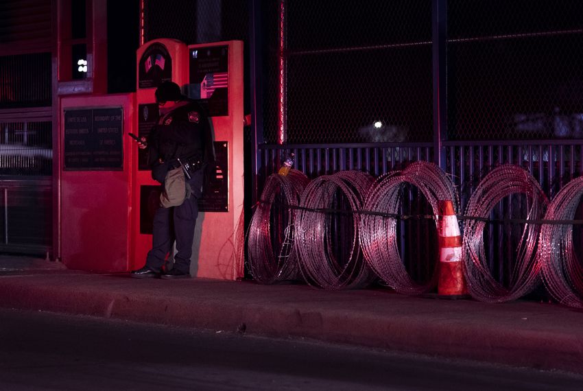 A U.S. Border Patrol agent stands at the U.S.-Mexico border in Eagle Pass.