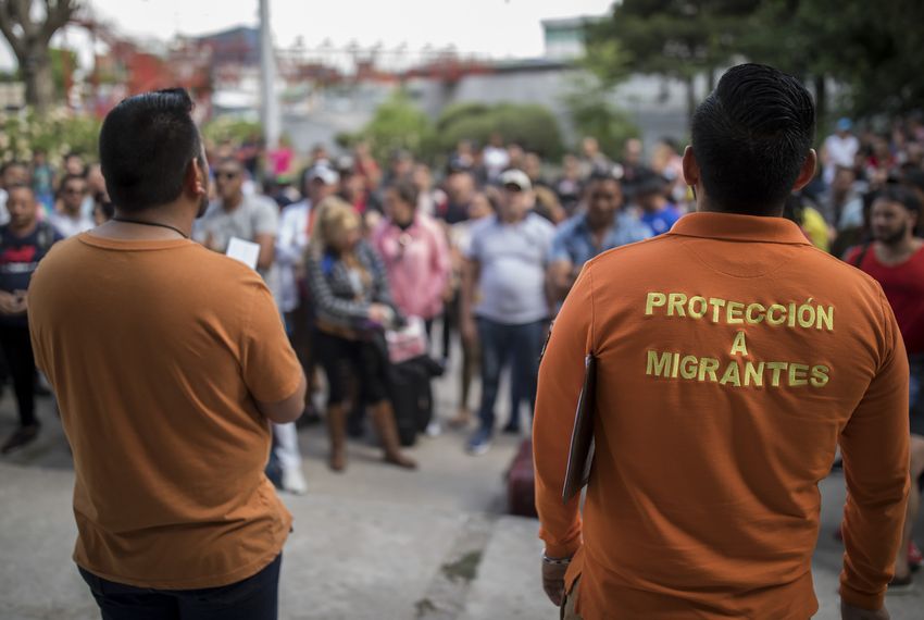 Workers from the state of Chihuahua's migrant aid agency call out numbers in Ciudad Juárez. Migrants go the agency's office twice a day to wait for their numbers to be called so they can enter the U.S. to be processed by U.S. immigration officials.