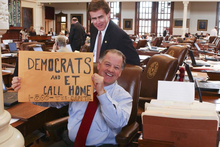 State Rep. Tommy Merritt, R-Longview holds a sign while Rep. Dan Branch, R-Dallas watches during the Texas House Democratic …