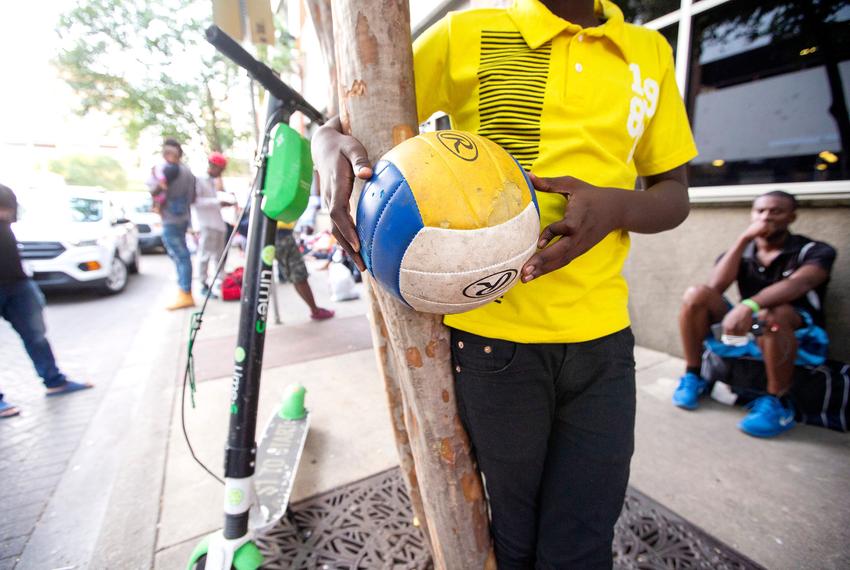 Children read and play outside a makeshift center  on June 26, 2019. Large groups of migrants, mostly from Africa have been arriving to somewhat makeshift shelters in downtown San Antonio