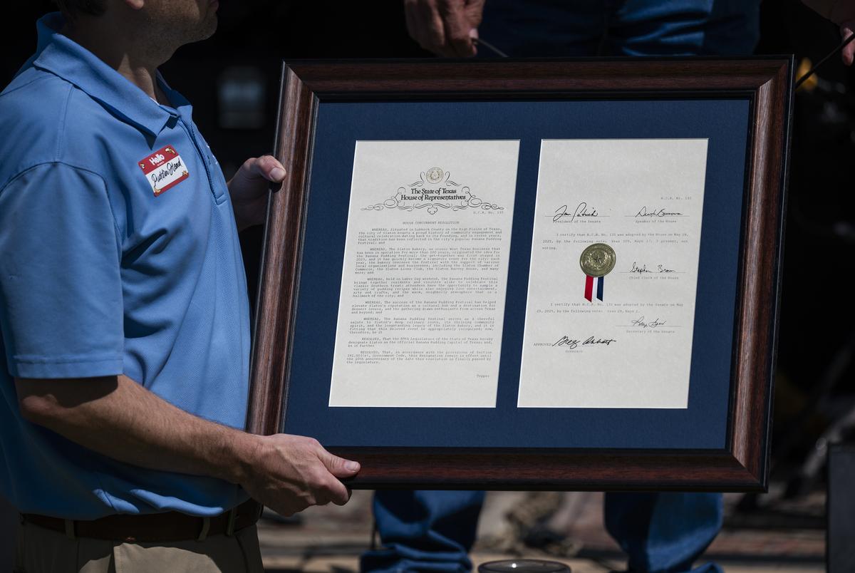 Chad Wilson holds a house resolution presented to the Salon Bakery at the Texas Banana Pudding Festival Saturday, Aug. 30, 2025, in Slaton, Texas.