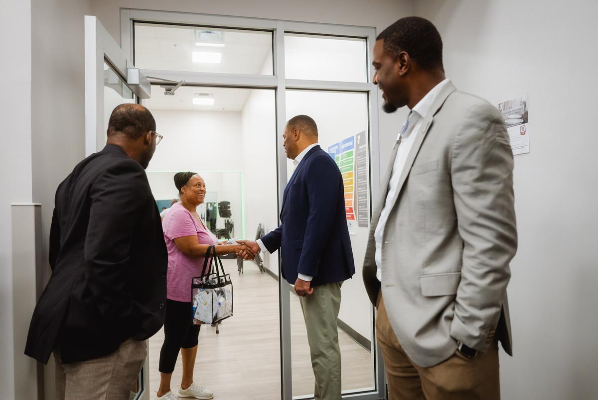FORT WORTH, TEXAS — AUGUST 22, 2025: U.S. Rep. Marc Veasey, D-Fort Worth, second from right, shakes hands with  constituent Cee Ellis during a tour of the Eastside YMCA in Fort Worth, Texas, on Aug. 22, 2025. Rep. Veasey helped secure federal funding to revitalize the Eastside YMCA. His congressional district will be significantly altered under newly approved redistricting map passed by the Texas Legislature, which would remove Fort Worth, his hometown and political base, and shift the district entirely into Dallas County. CREDIT: Desiree Rios for The Texas Tribune