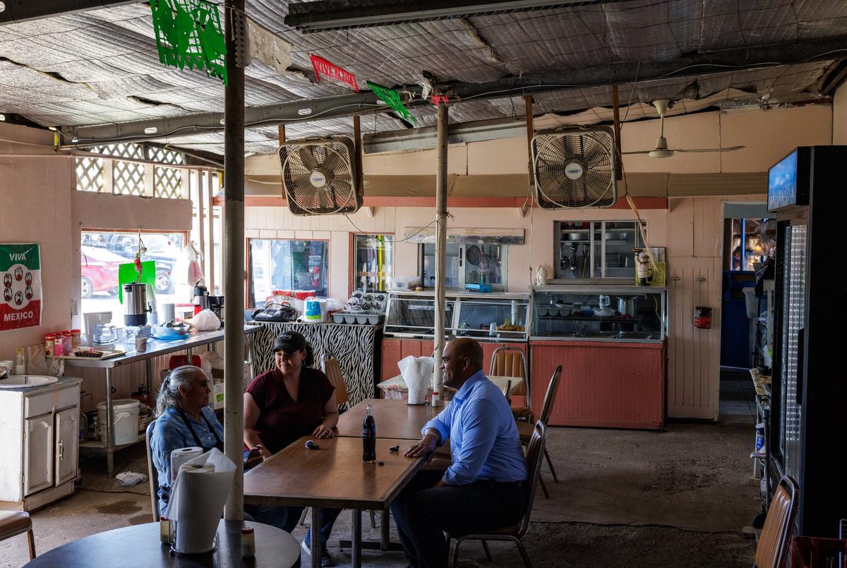 Former U.S. Rep. Colin Allred and former TX-15 Democratic candidate Michelle Vallejo talk to Hilda Lopez, the owner of the restaurant La MalagueÒa at Pulga Los Portales in Alton on Oct. 2, 2025.