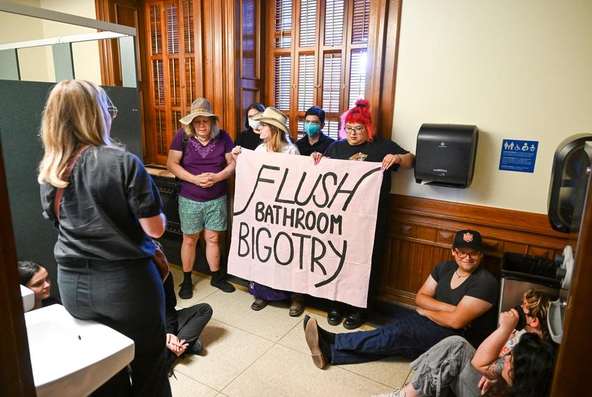 Activists from Trans Texas occupy the women's restroom on the first floor of the Texas Capitol after the House State Affairs Committe heard testimony on the "bathroom bill" on August 22, 2025.