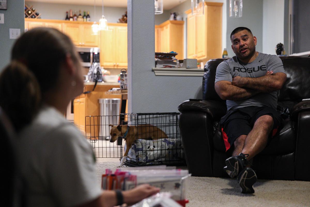 Cardenas talks with her husband, Rick, in their home on May 24, 2022.