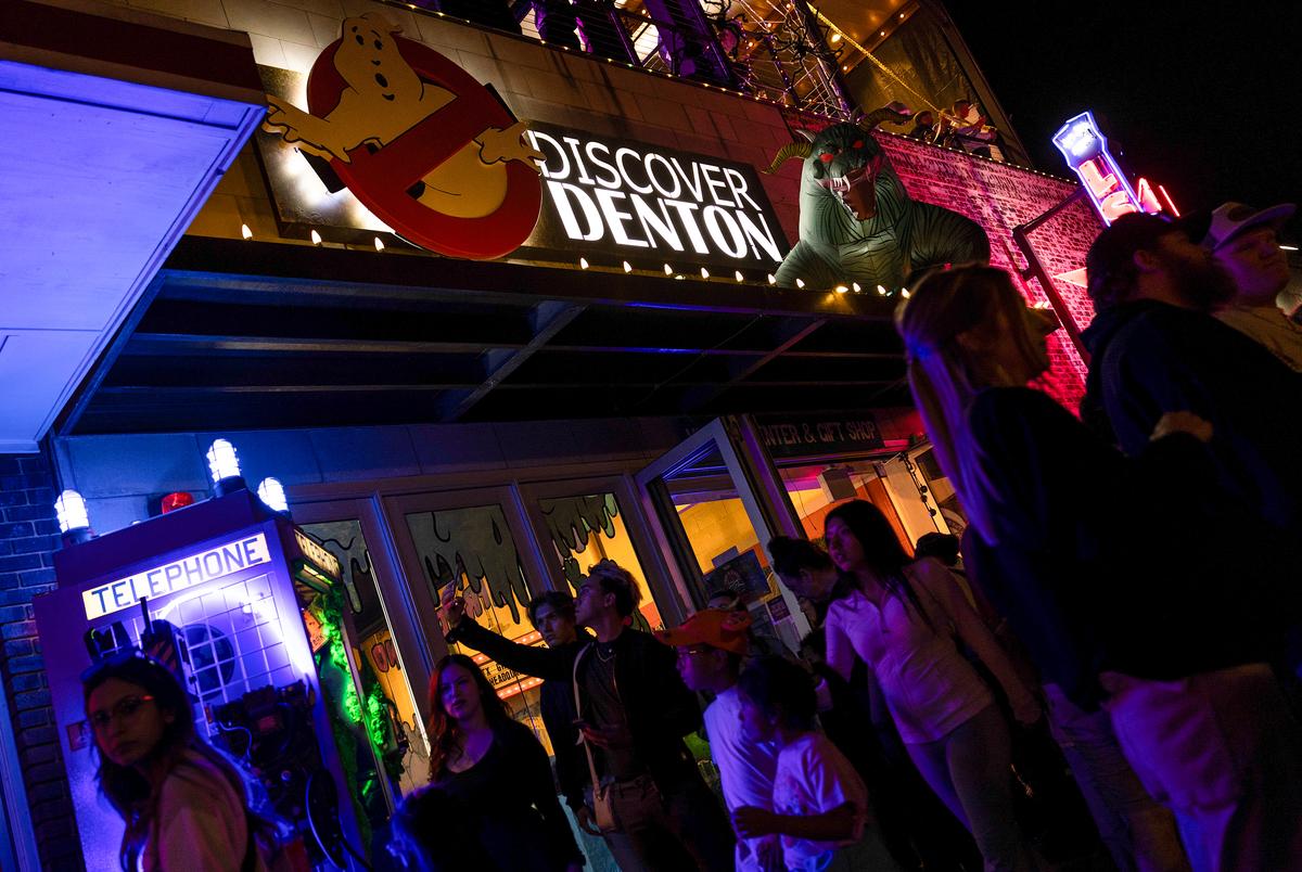 People go in and out of Discover Denton, enjoying an evening of Halloween and interaction on the square on Friday, Oct. 18, 2024 in Denton, Texas. The town has been hosting 31 days of Halloween, including multiple activities per day and a town full of Halloween decorations.
