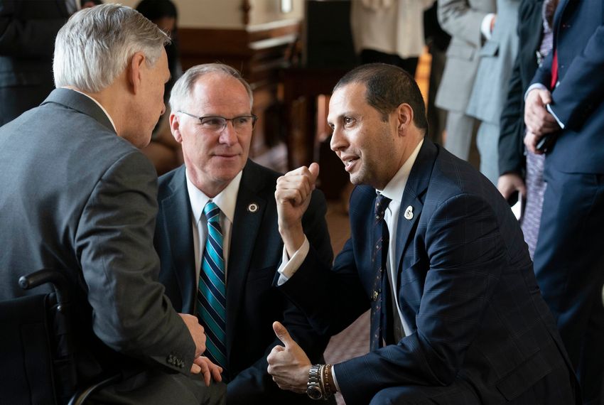 From left: Gov. Greg Abbott talks with state Reps. Kyle Biedermann, R-Fredricksburg, and Poncho Nevárez, D-Eagle Pass, on the House floor in Austin.