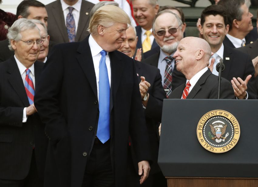 President Donald Trump and House Ways and Means Committee Chairman Kevin Brady smile at each other as Senate Majority Leader Mitch McConnell (L), Vice President Mike Pence, U.S. Rep Don Young and Speaker of the House Paul Ryan look with other Congressional Republicans after the U.S. Congress passed sweeping tax overhaul legislation, on the South Lawn of the White House in Washington, U.S., December 20, 2017. REUTERS/Jonathan Ernst