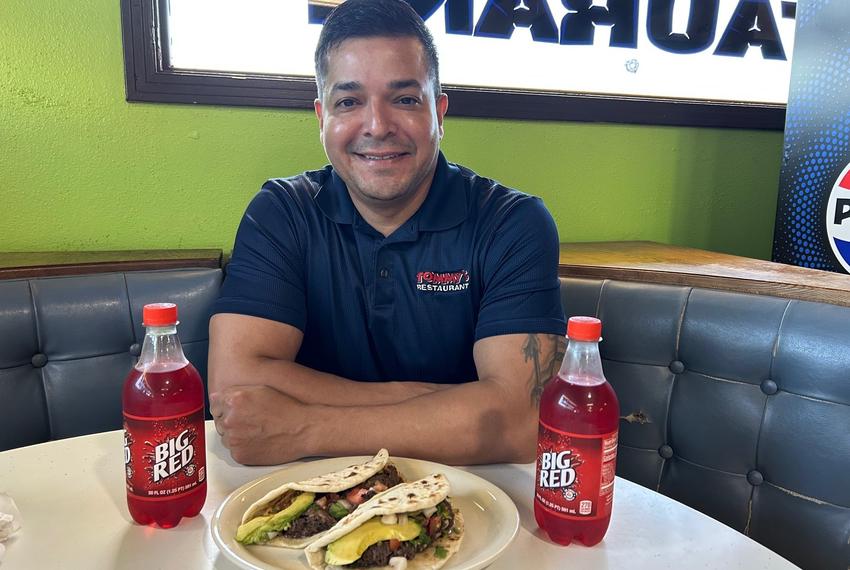 Brandon Ramos, owner of Tommy’s Restaurant, with the Guac My World breakfast: barbacoa tacos and Big Red.