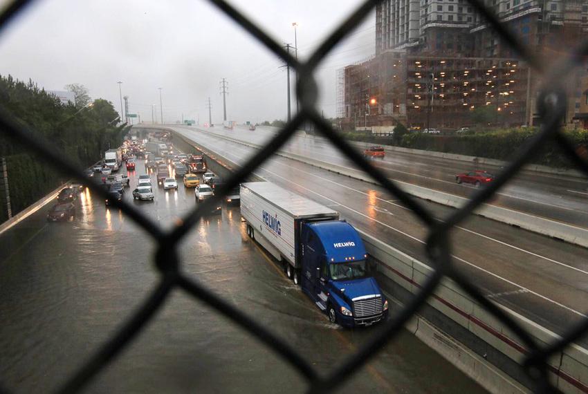 Drivers attempt to cross the floodwaters on Highway 59 in Houston on April 18, 2016.