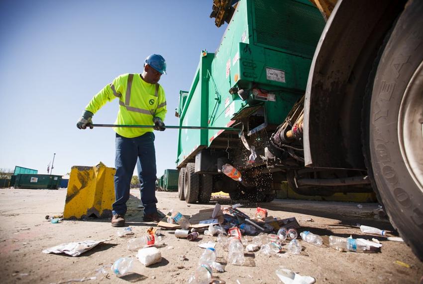 Glenn Bailey cleans out the Houston recycling truck he drives after dropping off a load at a waste management facility on March 18, 2014.