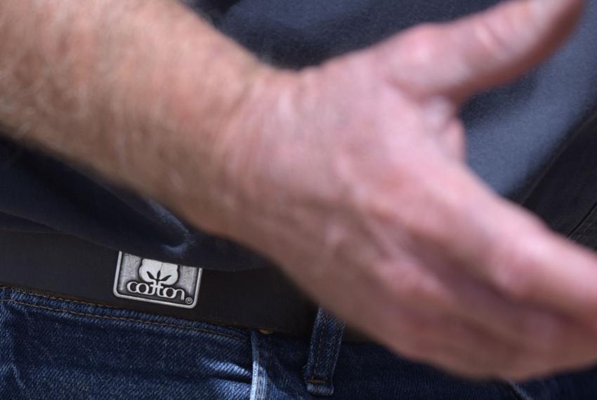 Walt Hagood wears a belt with a “cotton” logo on it. Hagood has been planting cotton since 1979.