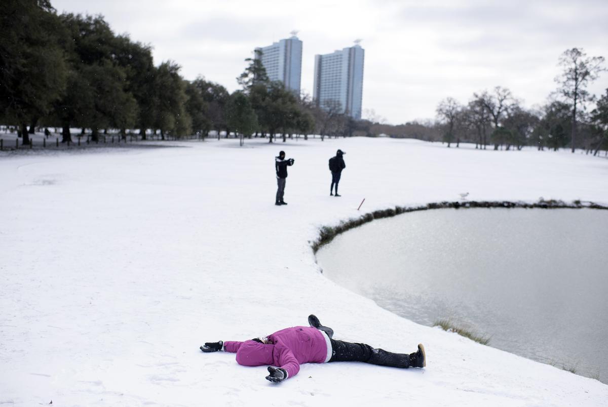 Mia Natali does snow angels at Hermann Park in Houston on Feb. 15, 2021.